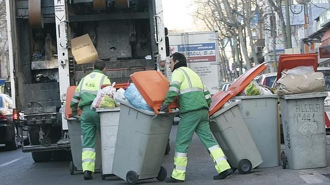 Los operarios municipales recogen los contenedores de basura