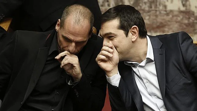 El primer ministro griego Alexis Tsipras (dcha) conversa con el ministro de Finanzas, Yanis Varufakis