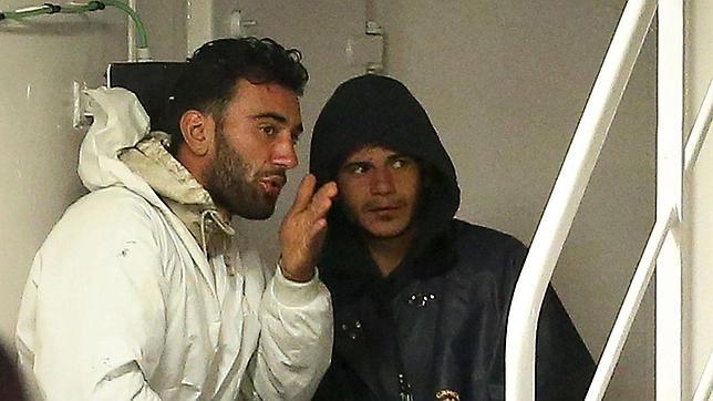 Mohamed Ali Malek (i) y Mahmud Bikhit hablan antes de desembarcar en Catania (Italia)