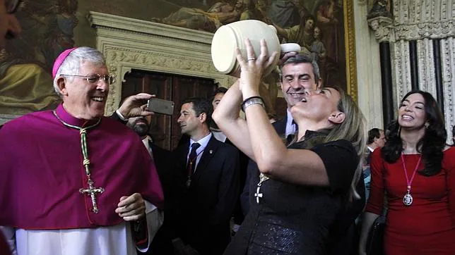 La alcaldesa alza el botijo en presencia del arzobispo y el presidente de la Diputación