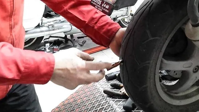 Para reparar un pinchazo hay que introducir una mecha de caucho en el agujero de la rueda
