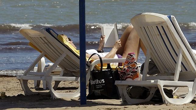 Una mujer disfruta de una soleada jornada en la playa de Valencia