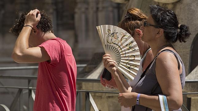 Unas turistas se abanican mientras soportan altas temperaturas en Sevilla