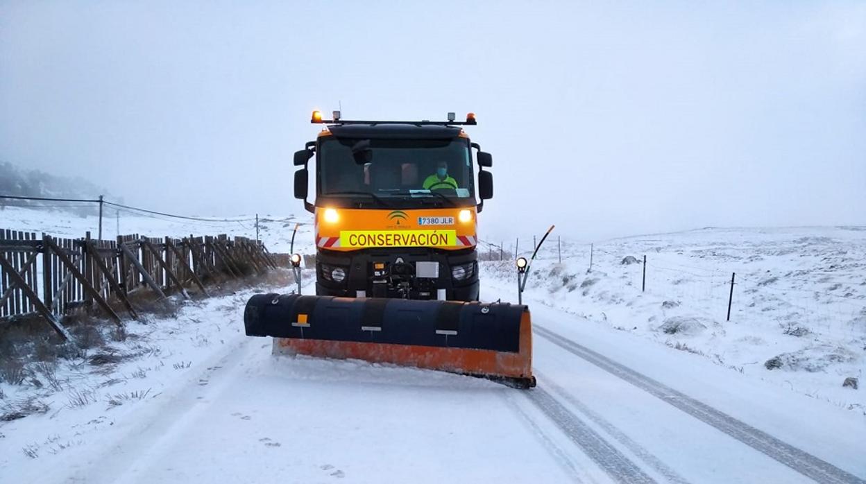 Una máquina quitanieves se afana en la retirada de la nieve de una carretera.