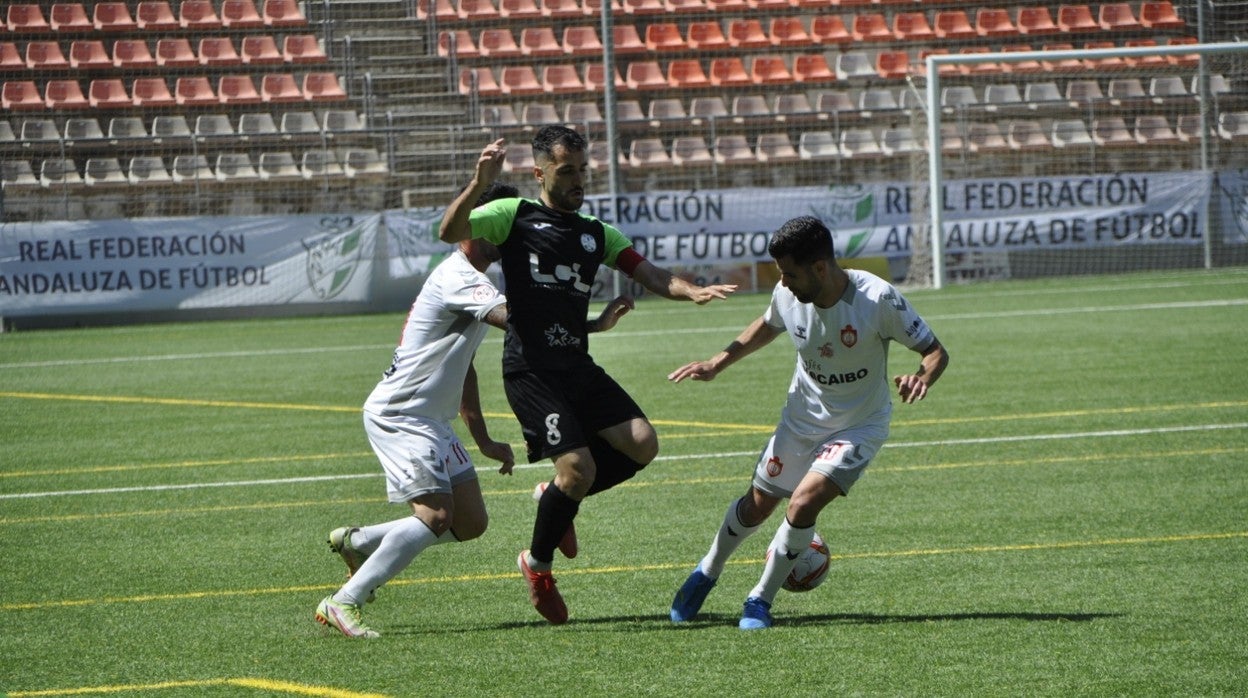 Mario Ruiz lucha por el balón ante los rivales del CD Utrera