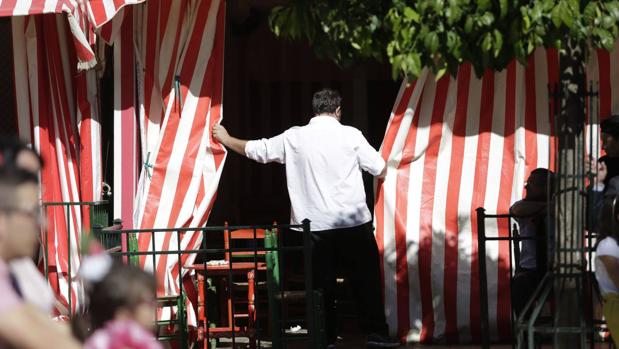 Un camarero cierra una caseta este sábado en la Feria