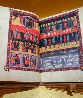 Imagen secundaria 2 - Arriba, la directora de la BNE, Ana Santos, junto al vicepresidente de Cantabria, Pablo Zuloaga. En la exposición hay 25 piezas, entre ellas una edición facsímil del Beato, como se muestra en la última fotografía