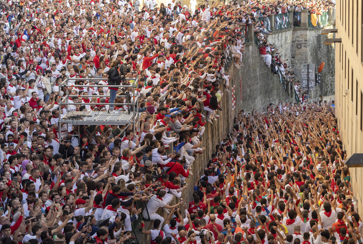 Corredores entonan el cántico ante la hornacina a San Fermín de la cuesta de Santo Domingo de Pamplona en los momentos previos al segundo encierro de los Sanfermines 2023