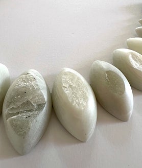 Imagen secundaria 2 - Arriba, una mujer contempla las obras de Patricia Dauder en ProjesteSD. Sobre estas líneas, obra de Joan Fontcuberta generada con IA en Àngels Barcelona y joyas funerarias de talco de Teresa Estapé en Chiquita Room