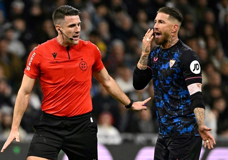 El colegiado Díaz de Mera dialoga con el jugador del Sevilla Sergio Ramos
