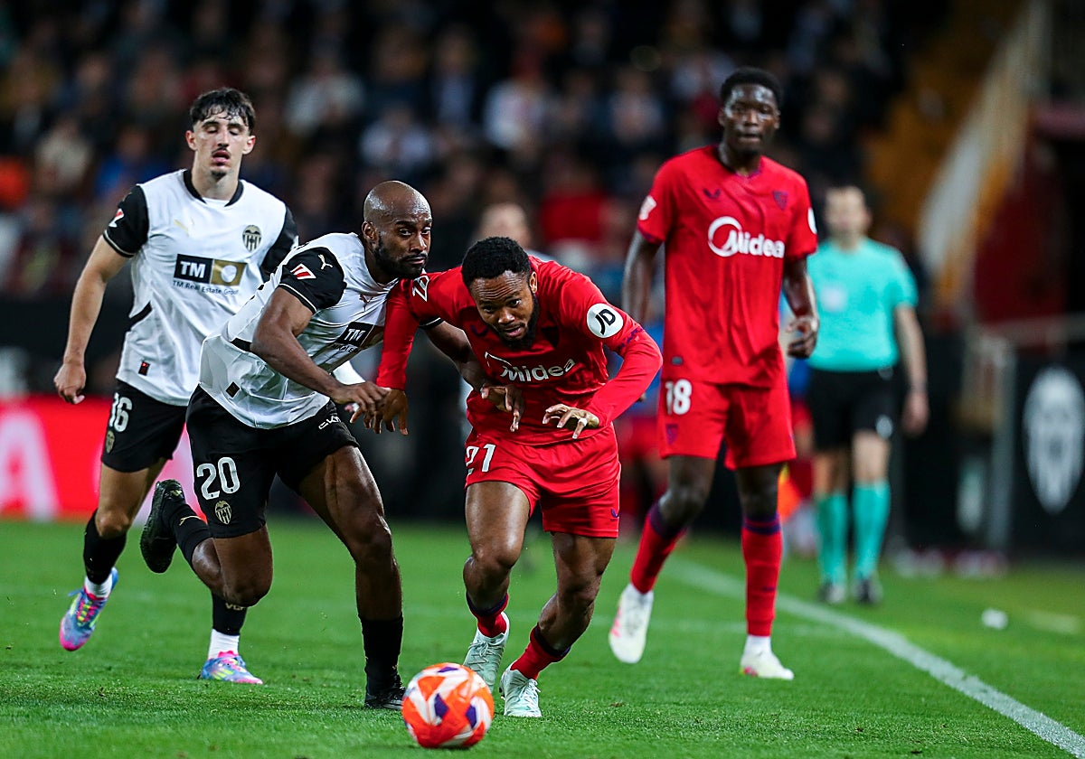 Chidera Ejuke pugna un balón con Dimitri Foulquier en el Valencia - Sevilla de la temporada 24-25
