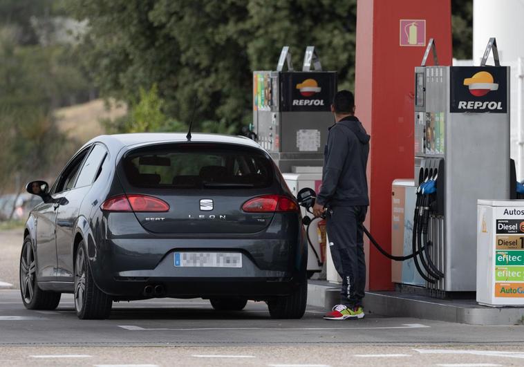 A man refueling his car at a petrol station in Madrid