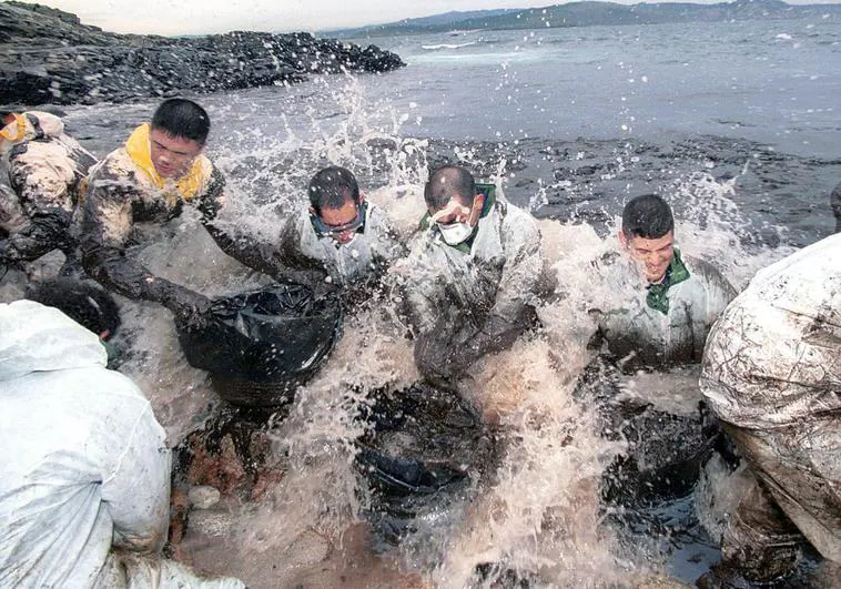 Voluntarios recogiendo chapapote del vertido del Prestige en las islas Cíes
