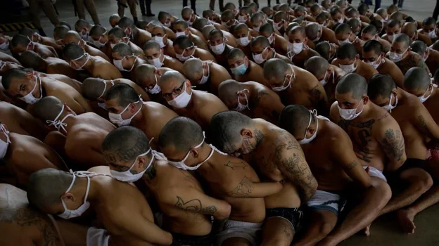 Gang members from Mara Salvatrucha and Barrio 18 stay together in formation at the maximum security penal center in Izalco.  It was a measure of punishment imposed by Bukele after a spike in murders, which, however, did not last, even though the photo went viral.