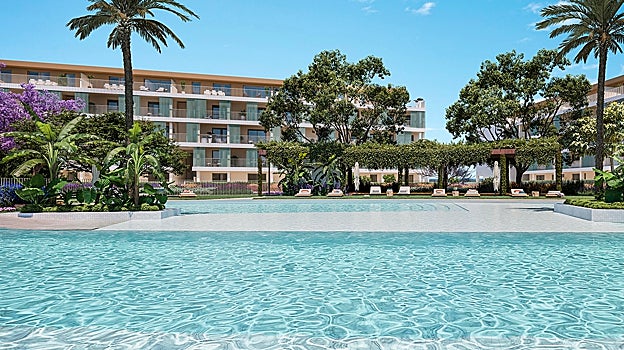 Piscina y jardines en una zona común de la promoción de viviendas