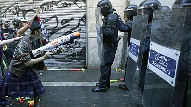 Mossos frente a miembros de colectivos okupas, durante una intervención en Barcelona