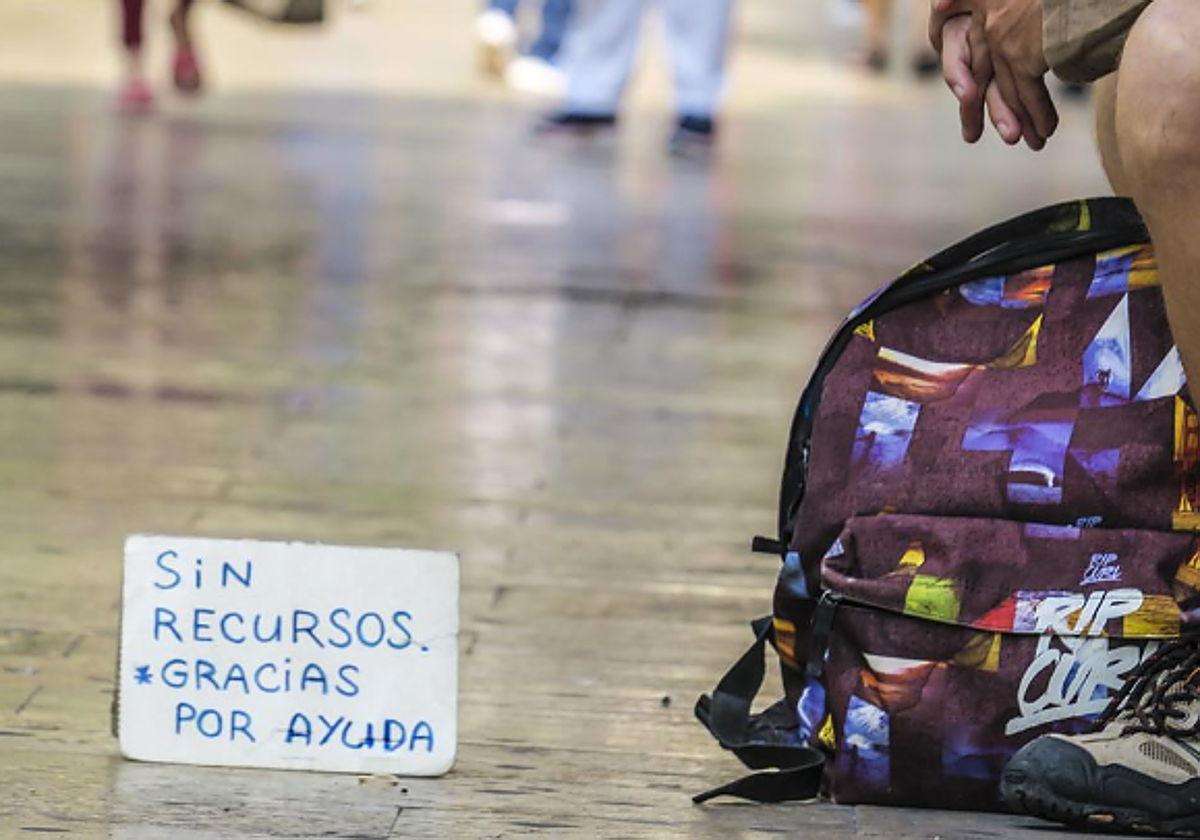 Una persona muestra un cartel pidiendo ayuda en foto recurso