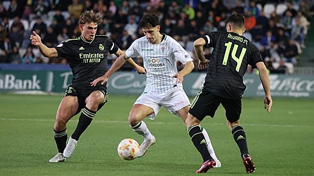 Marco Camus, entre dos rivales del Real Madrid Castilla