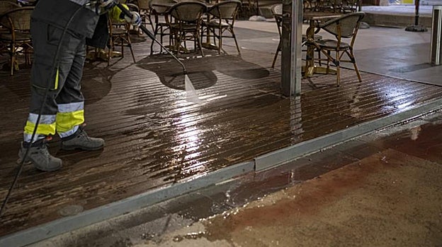 Labores de limpieza en la calle donde se produjo el tiroteo