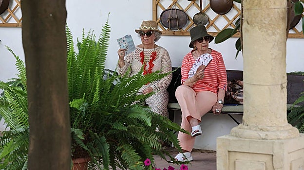 Dos mujeres se refrescan en uno de los Patios de Córdoba