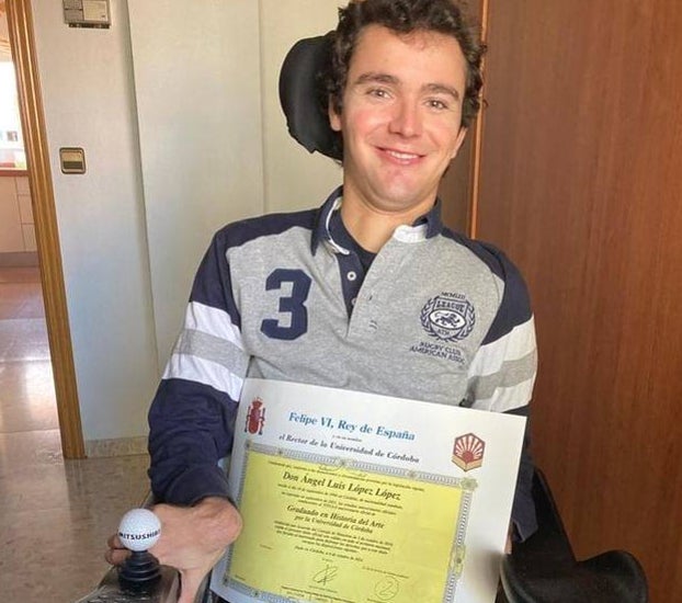 Ángel, mostrando su título de graduado en Historia del Arte