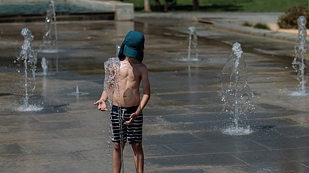 Imagen de un niño refrescándose en una fuente del Parc Central de Valencia