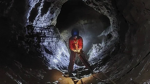 Desciendo a uno de los pozos de la cueva del Rei Cintolo