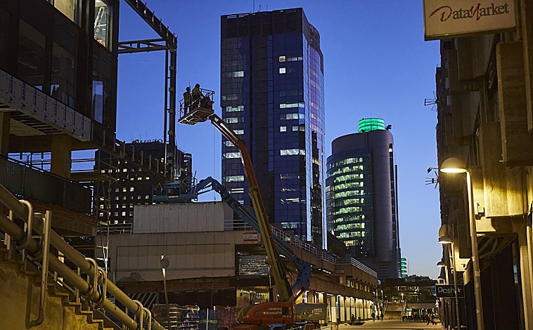 Imagen principal - En la imagen principal, el paseo entre la calle Orense y la plaza de Azca donde se rematan las obras de un edificio de oficinas. Después, una de las escaleras retorcidas que terminan en rincones oscuros. En algunos, los vecinos han colgado carteles para advertir a los sintecho. 