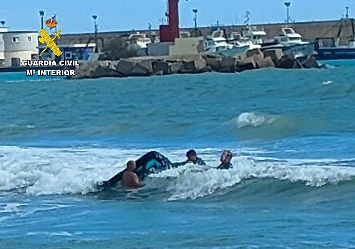Imagen de la Guardia Civil auxiliando al surfista en Villajoyosa