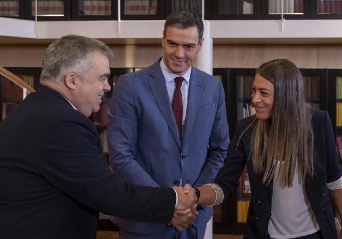 El número tres del PSOE, Santos Cerdán, saluda a la portavoz de Junts en el Congreso, Miriam Nogueras, ante la mirada de Pedro Sánchez