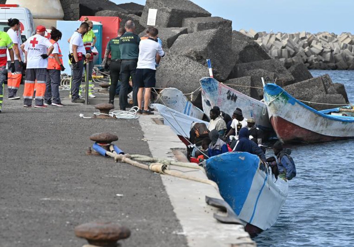 Una embarcación llega a las costas de Canarias este mes ante la mirada de miembros de la Guardia Civil y Cruz Roja