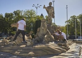 Un grupo de expertos analiza la escultura al dios Neptuno, este martes, en el paseo del Prado