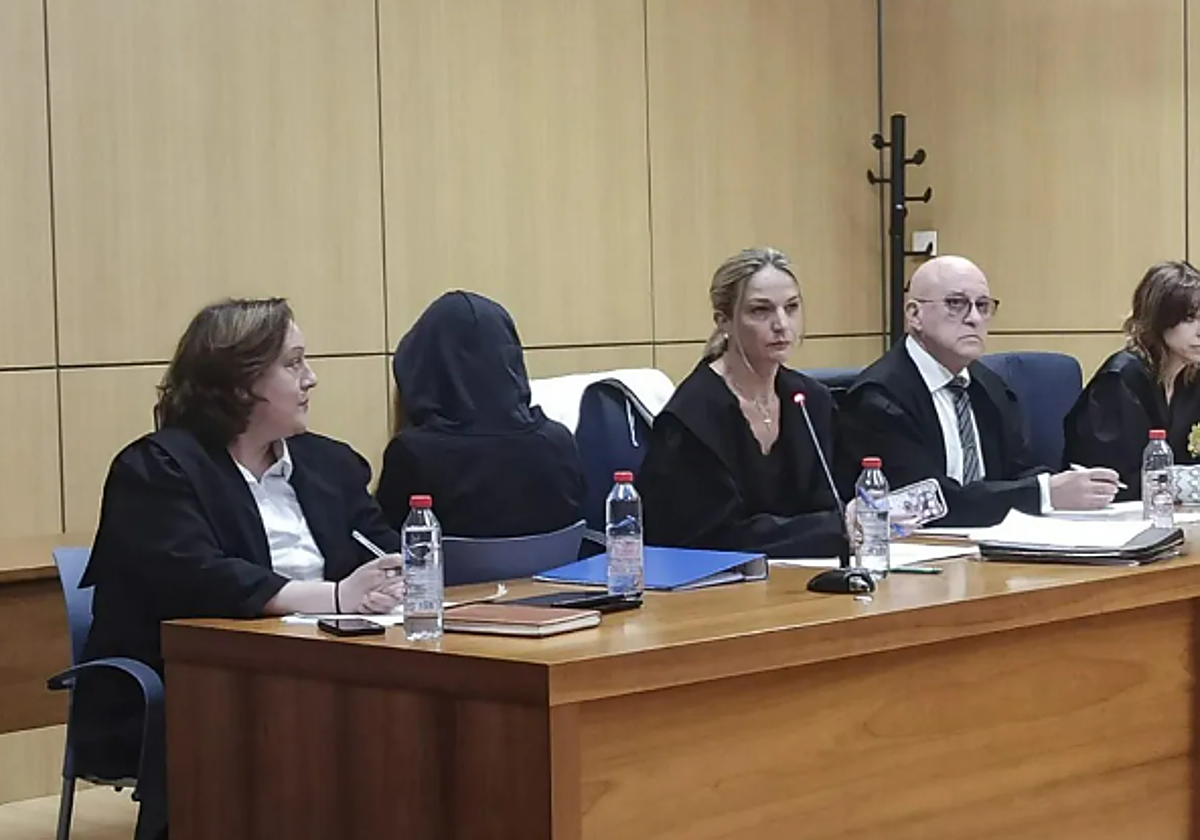 La joven que confesó haber matado a su madre, de espaldas con una capucha durante el juicio en Valencia