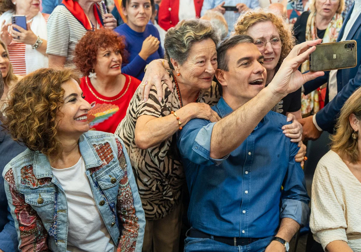 Sánchez se fotografía junto a dos asistentes al mitin de Benalmádena en presencia de María Jesús Montero