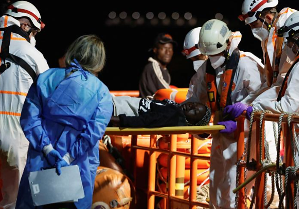 Equipos de emergencia trasladan en camilla a una persona rescatada de un cayuco en  Gran Canaria, en julio