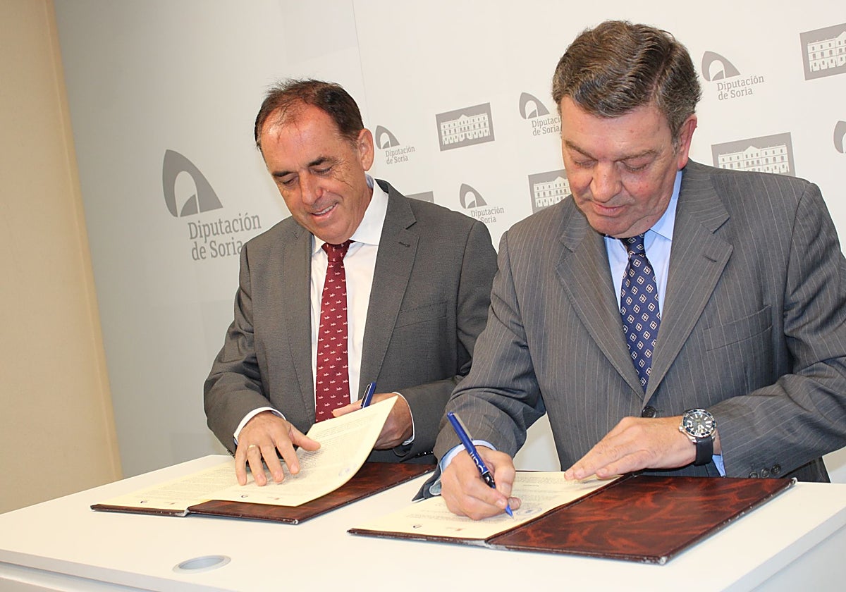 El consejero de la Presidencia, Luis Miguel González Gago (d), y el presidente de la Diputación de Soria, Benito Serrano (i), firman el protocolo para la rehabilitación y el uso compartido del edificio de la Casa de Soria en Madrid.