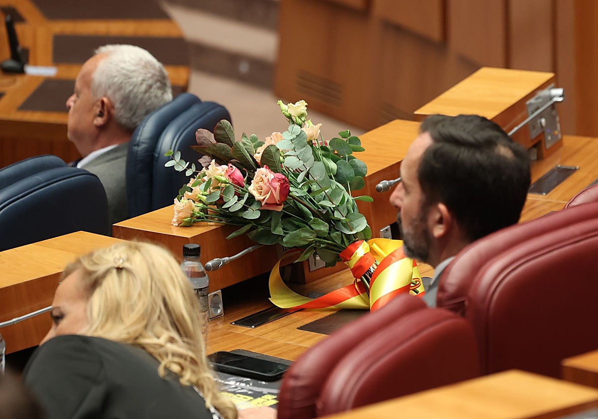 Un ramo de flores recuerda al fallecido Javier Carrera en la bancada de Vox.