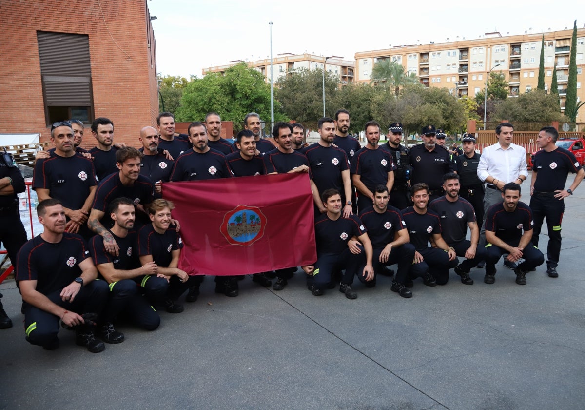 Bellido junto a los 22 bomberos que portan una bandera de Córdoba