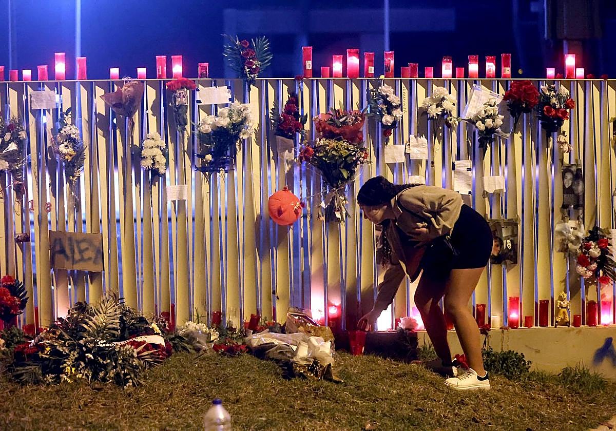 Una joven enciende una vela en recuerdo del joven asesinado