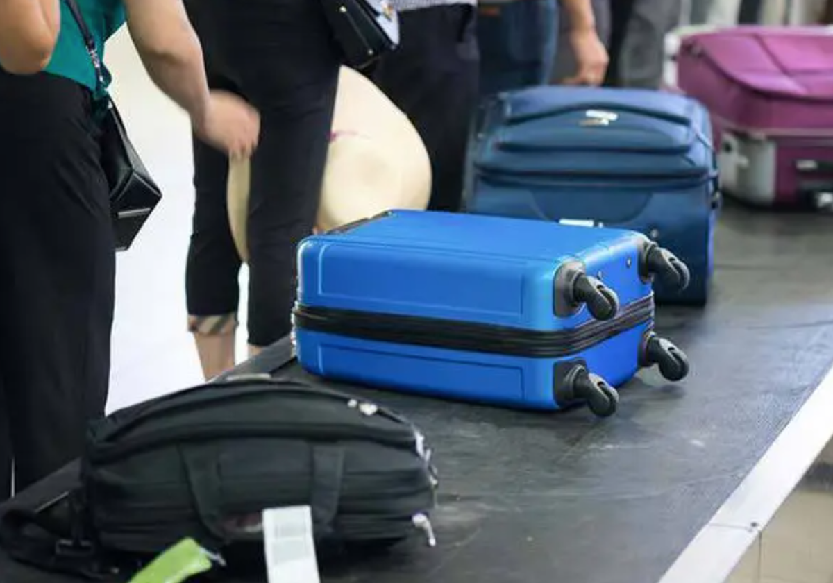 Varias maletas en una cinta transportadora de equipajes en un aeropuerto.