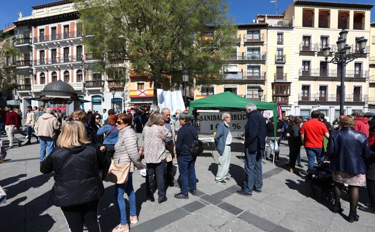 Imagen principal - Numerosas personas se han acercado hasta la plaza de Zocodover para mostrar su apoyo y defender una sanidad pública y de calidad. También han participado de la recogida de firmas