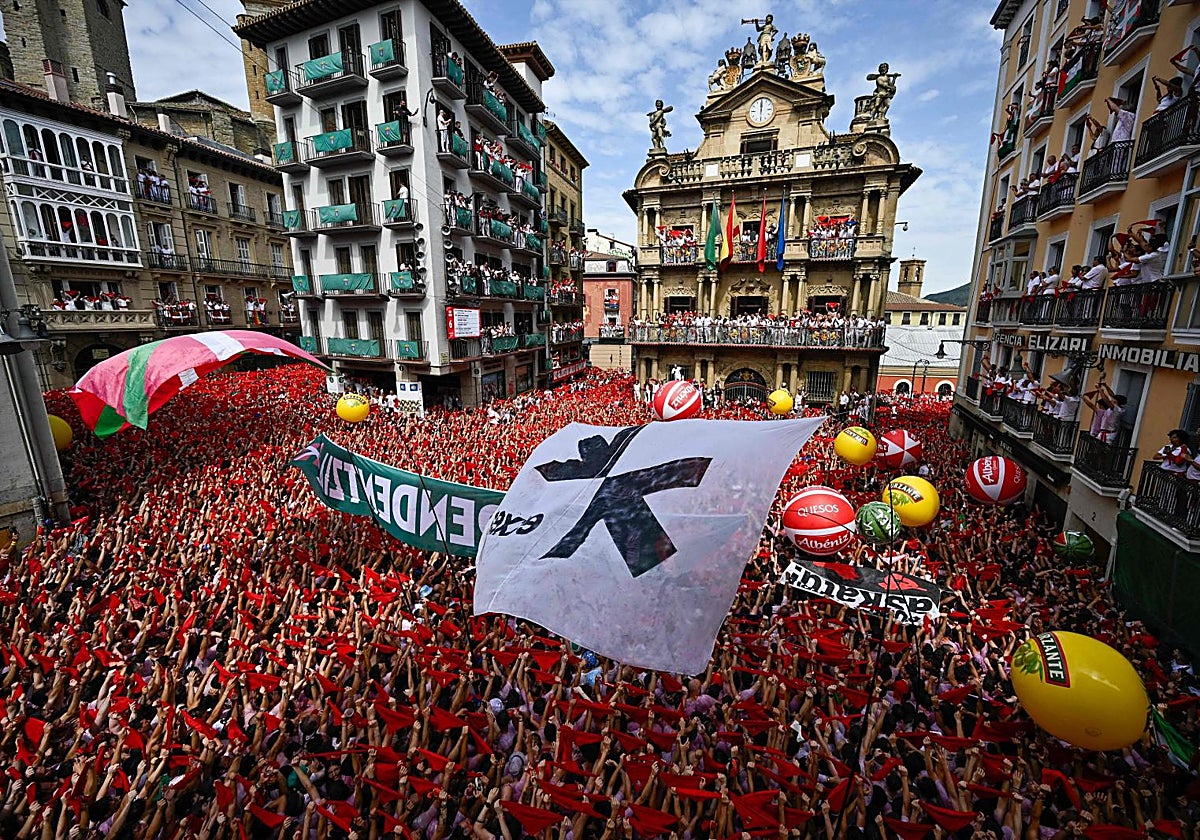 La bandera de Etxerat y otra reclamando la independencia durante el chupinazo este domingo en la plaza del Ayuntamiento de Pamplona