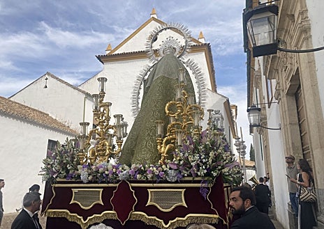 Imagen secundaria 1 - En la fotografía superior, la Reina de los Ángeles Gozosos, de perfil, en la plaza eddCapuchinos. Debajo a la izquierda, vista del nuevo manto en brocatel verde, donado por hermanos por el Año Jubilar de la Esperanza. A la derecha, detalle de la ornamentación floral del paso