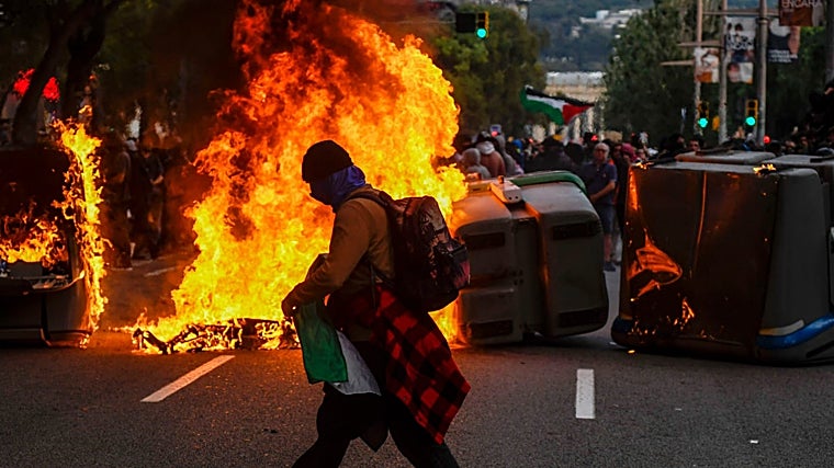 Contenedores en llamas en la calle Tarragona, durante la protesta propalestina en Barcelona