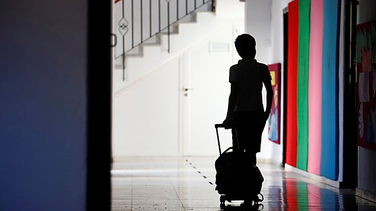 A boy in the hallway of his school