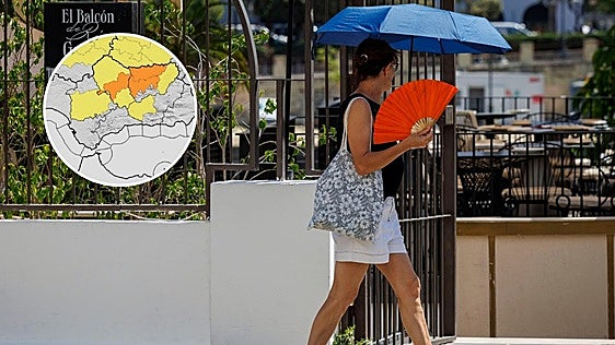 Una mujer se abanica y protege del calor en Sevilla en 2026