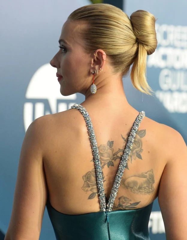 Scarlett Johansson sports a large tattoo on her back.