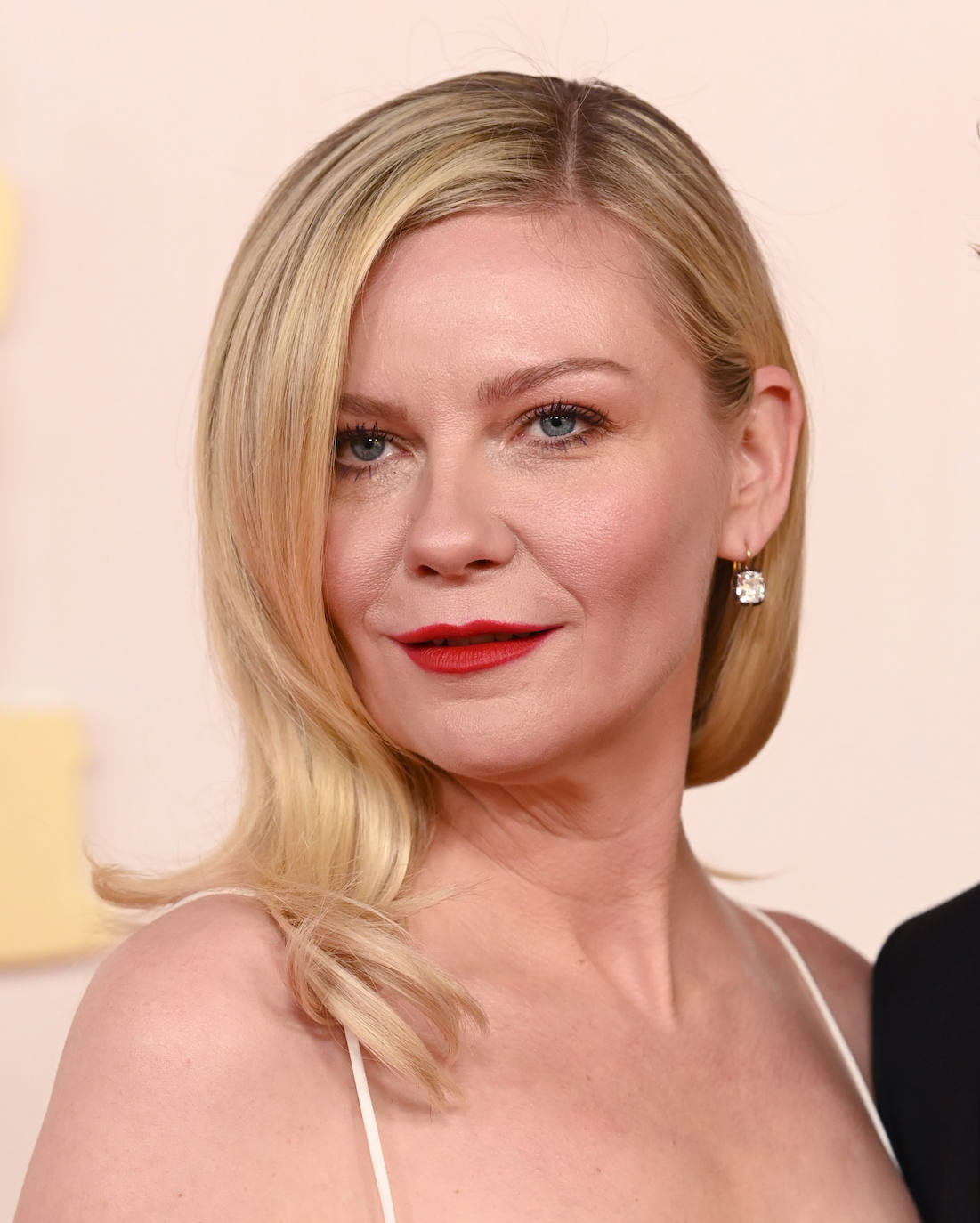 Kirsten Dunst fue otra de las que prefirió el pelo suelto, con ondas ligeras en las puntas. Para darle color a su estilismo (su vestido era blanco impoluto), eligió un labial rojo, que fue la nota más destaca de su maquillaje. 