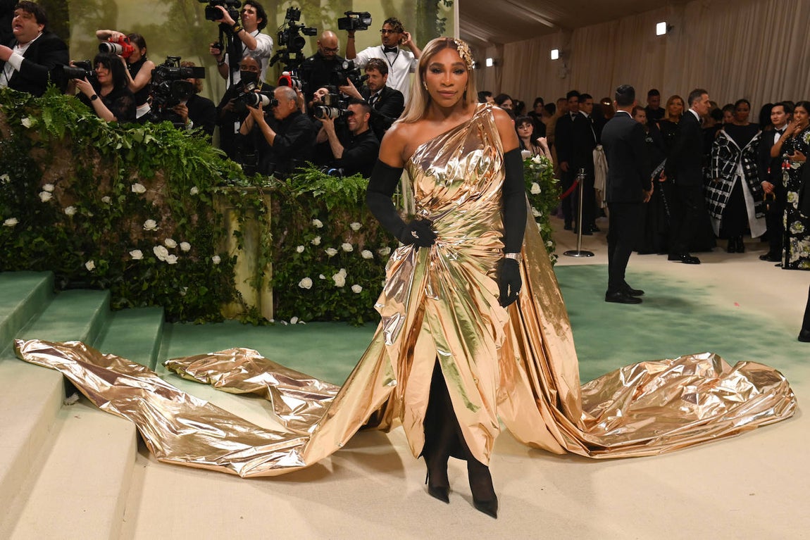 Serena Williams optó por un vestido en color oro que combinó con medias y guantes negros. 