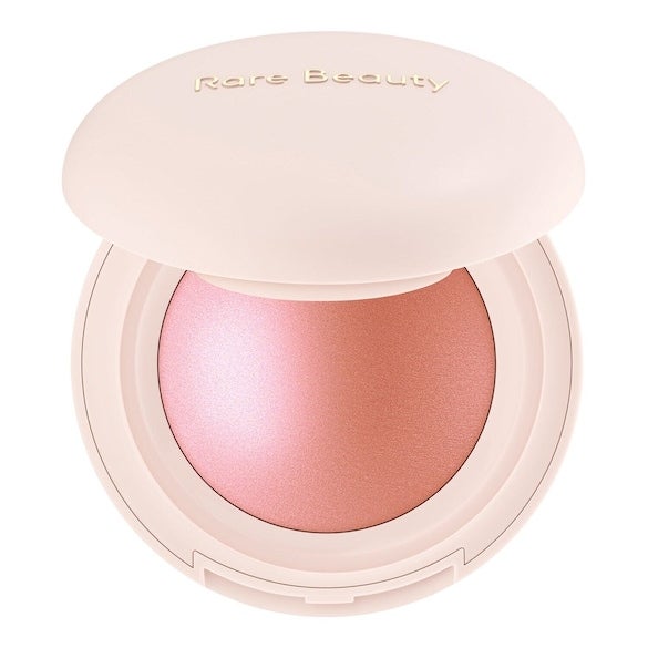 Colorete Soft Pinch Luminous Power Blush de Rare Beauty (26,99 euros, solo en Sephora). Suave y ligero, este colorete mezcla perfecta de Soft Pinch Liquid Blush y de positive Light Silky Touch añade a la piel un toque de color ligero, natural y sedoso para conseguir un rubor perfecto que parece irradiar desde el interior. Su base altamente pigmentada está enriquecida con partículas nacaradas brillantes que aportan una dimensión natural. No se cuartea, se apelmaza ni se cae. Su fórmula resistente al agua, a la transferencia y a las manchas mantiene el rubor durante todo el día. Disponible en seis tonos.